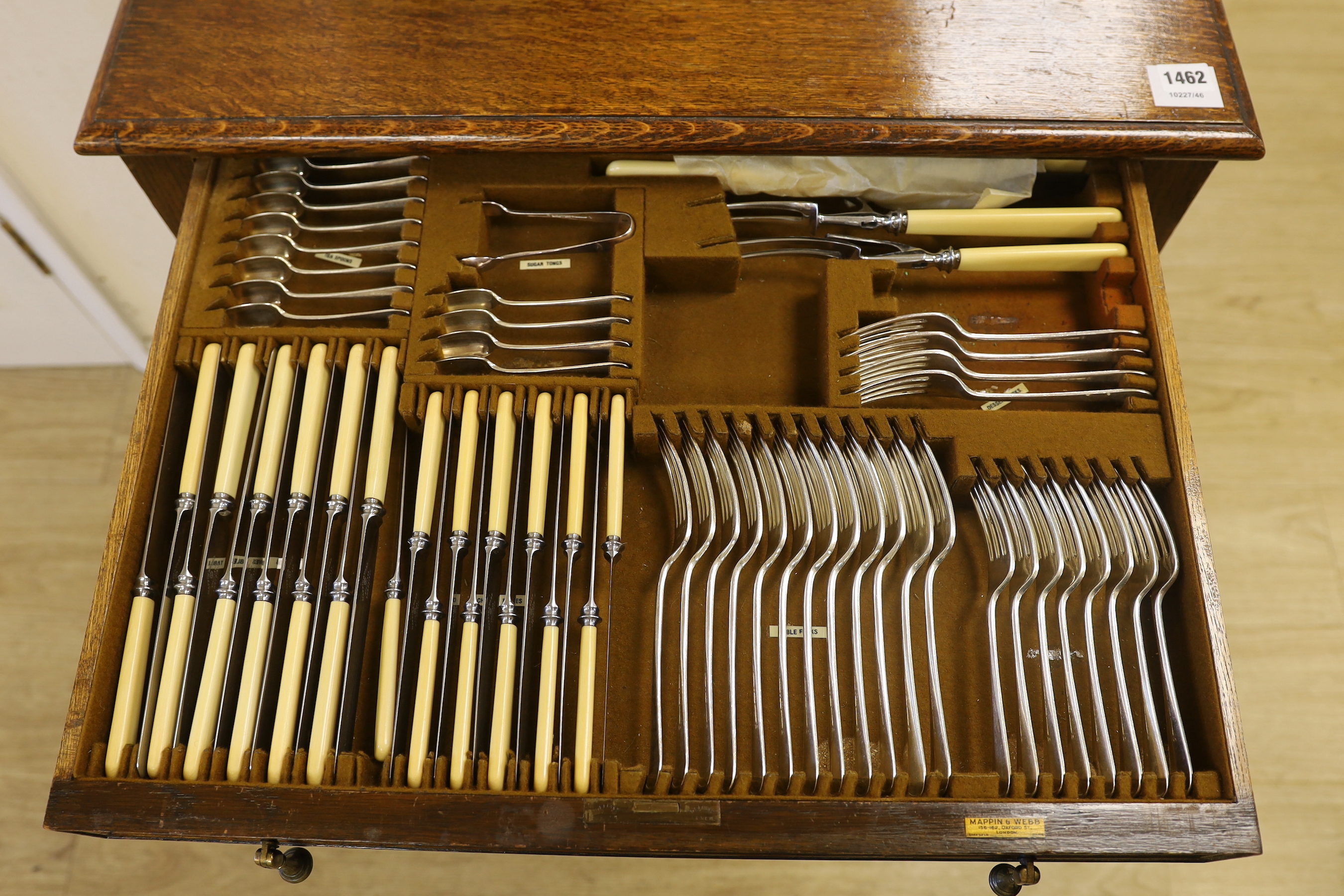 An oak standing canteen with two drawers of Mappin and Webb silver plated cutlery, settings for twelve people, 78cm high x 70cm wide x 54cm deep
